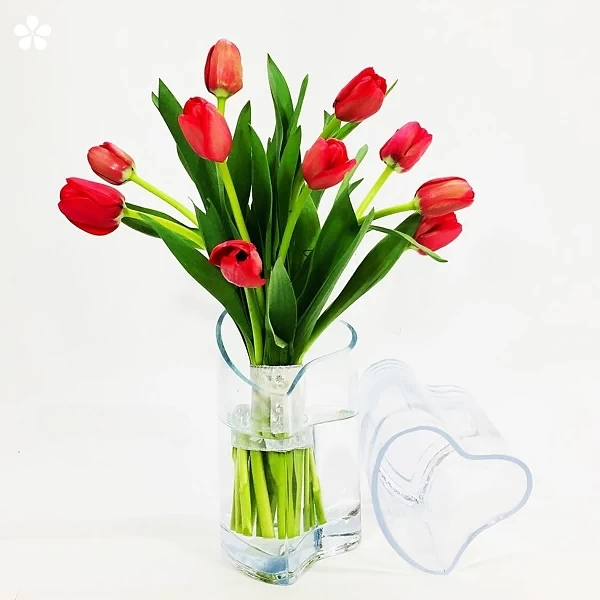 Corazón de cristal con tulipanes rojos